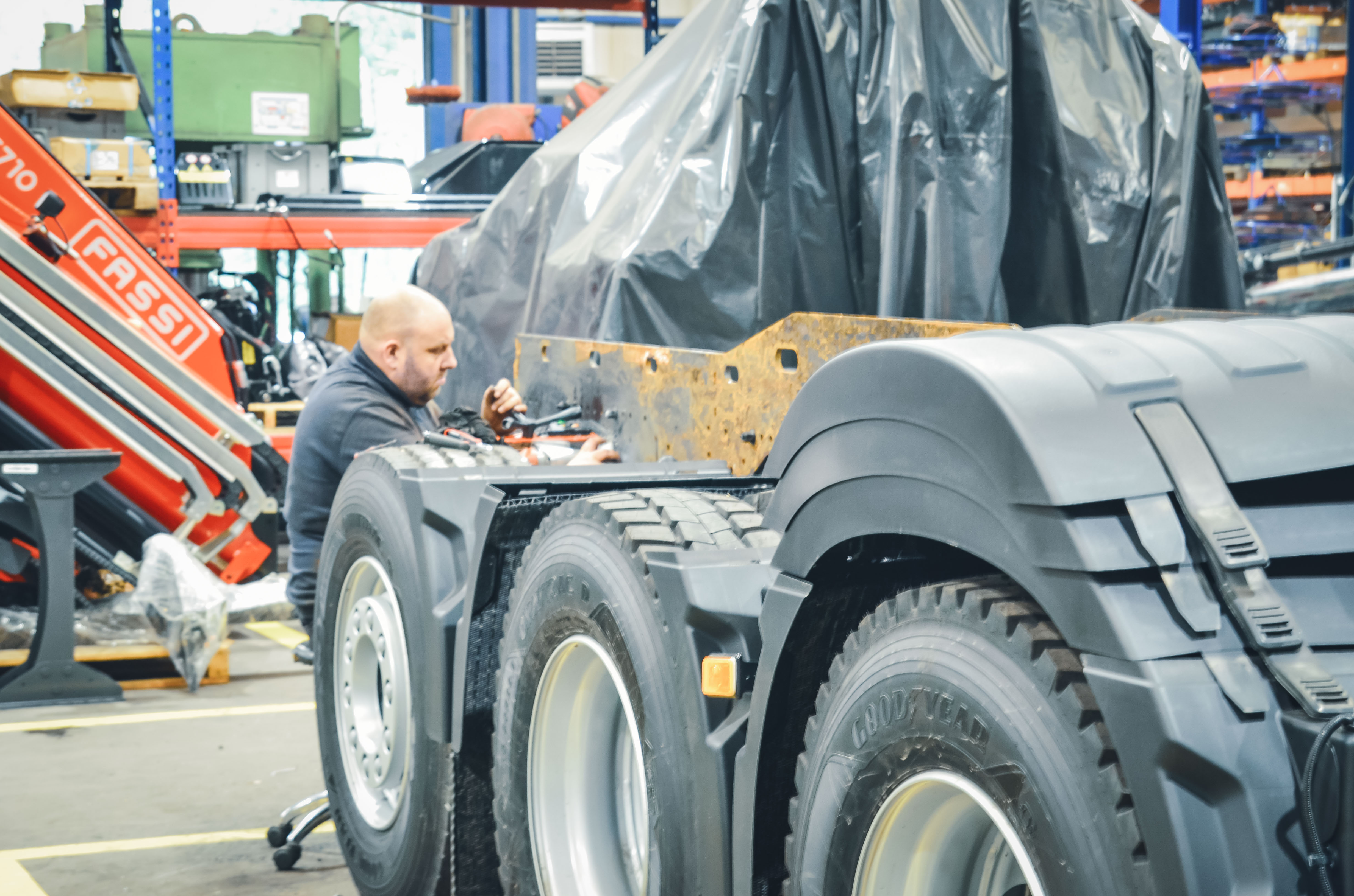 Workshop employee carrying out bodywork on a truck